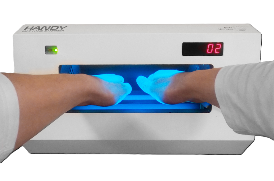 Hands positioned inside the illuminated HANDY chamber